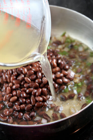 pouring chicken broth