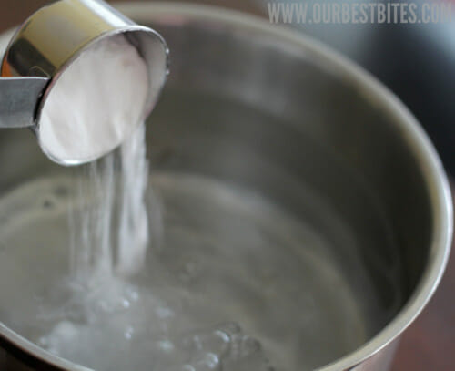 adding baking soda to water for pretzel rolls
